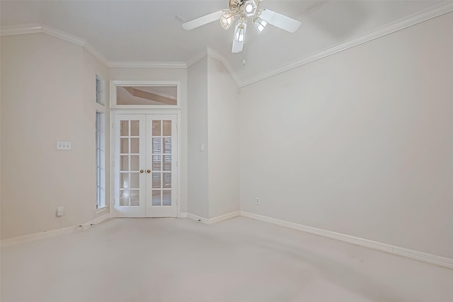 carpeted empty room with ornamental molding, ceiling fan, french doors, and baseboards