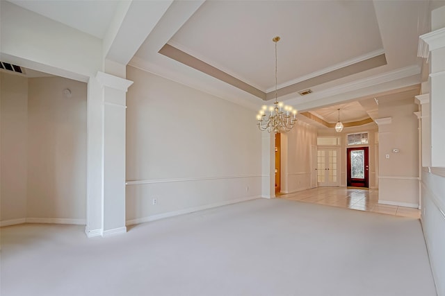 empty room featuring light carpet, visible vents, a tray ceiling, and crown molding