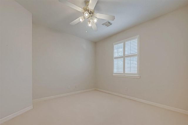 unfurnished room featuring a ceiling fan, visible vents, and baseboards