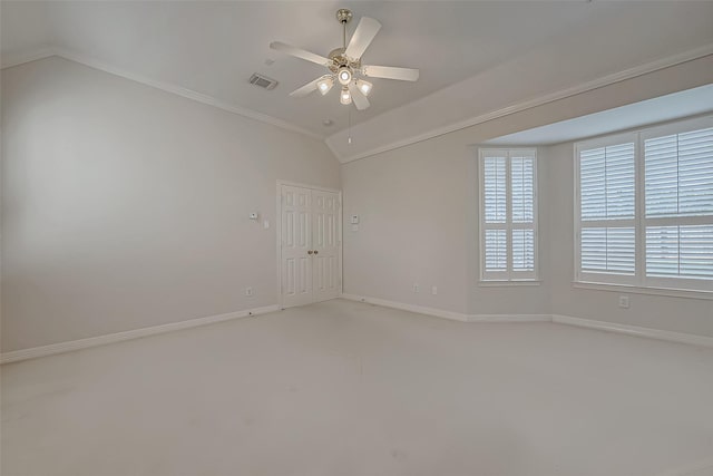 spare room with baseboards, visible vents, vaulted ceiling, and a ceiling fan