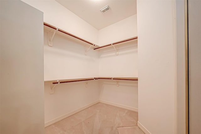 spacious closet with visible vents and light carpet