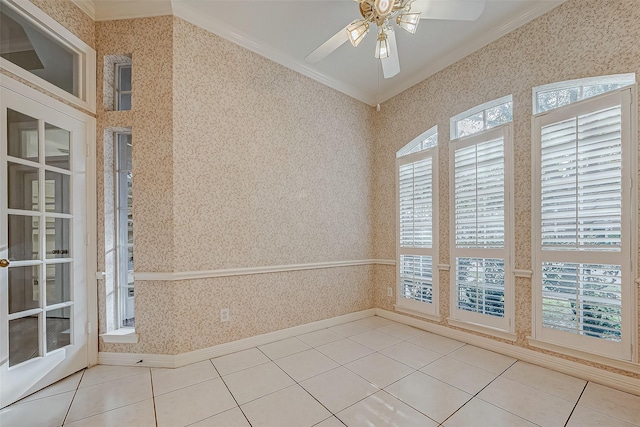 spare room with wallpapered walls, light tile patterned floors, and crown molding