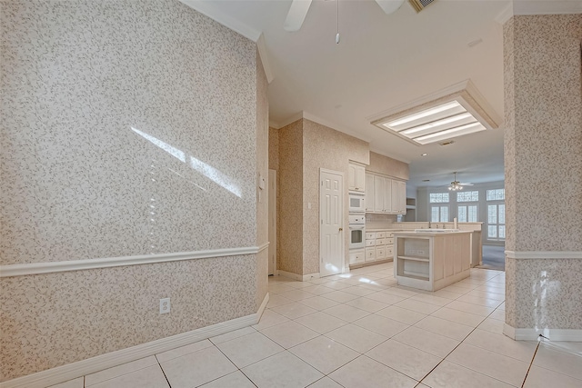 kitchen with wallpapered walls, light tile patterned floors, white appliances, a kitchen island, and open shelves