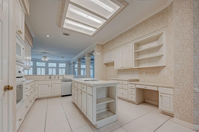 kitchen featuring open shelves, light countertops, ornamental molding, a kitchen island, and white appliances