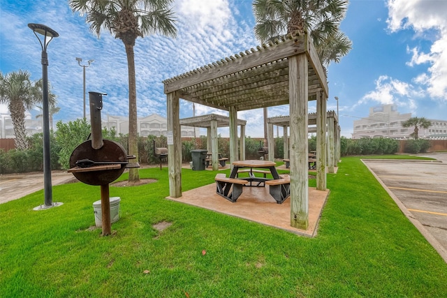 view of property's community featuring a yard and a pergola