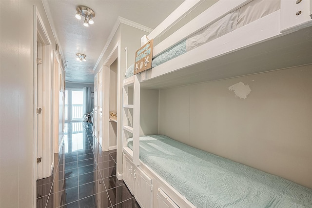 bedroom featuring dark tile patterned floors and ornamental molding