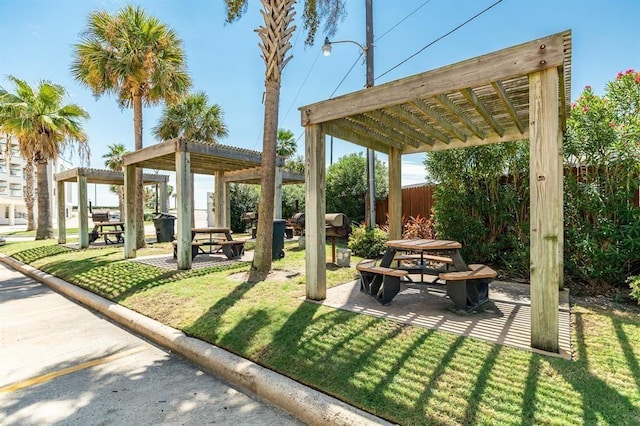 view of home's community featuring a patio area, a lawn, and a pergola