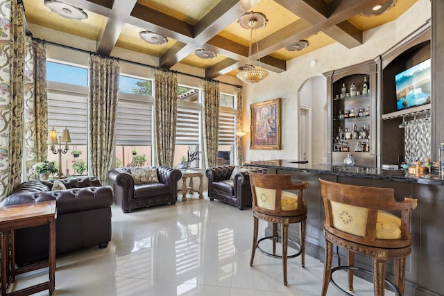 bar featuring wet bar, pendant lighting, coffered ceiling, and light tile patterned floors