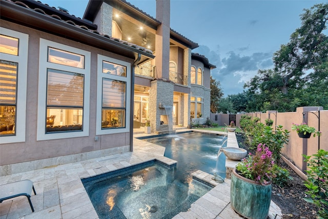 view of swimming pool featuring a patio area, a fenced backyard, a fenced in pool, and an in ground hot tub