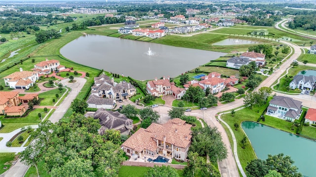 birds eye view of property with a water view and a residential view