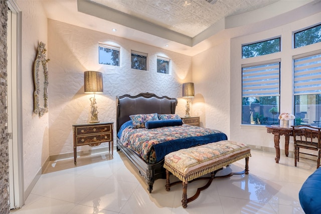 bedroom with baseboards and a textured wall