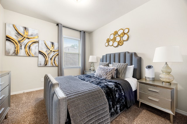 bedroom featuring dark colored carpet and baseboards