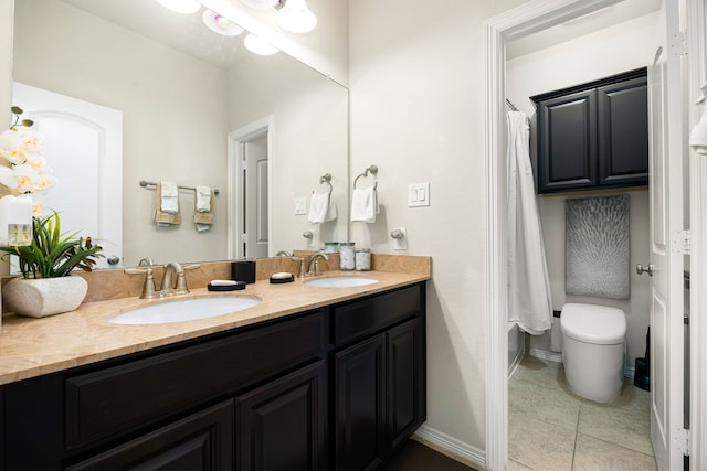 full bathroom featuring tile patterned floors, a sink, baseboards, and double vanity