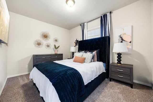 bedroom featuring light colored carpet and baseboards