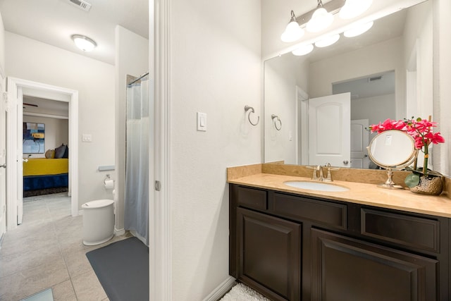 bathroom featuring visible vents, connected bathroom, vanity, tile patterned flooring, and baseboards