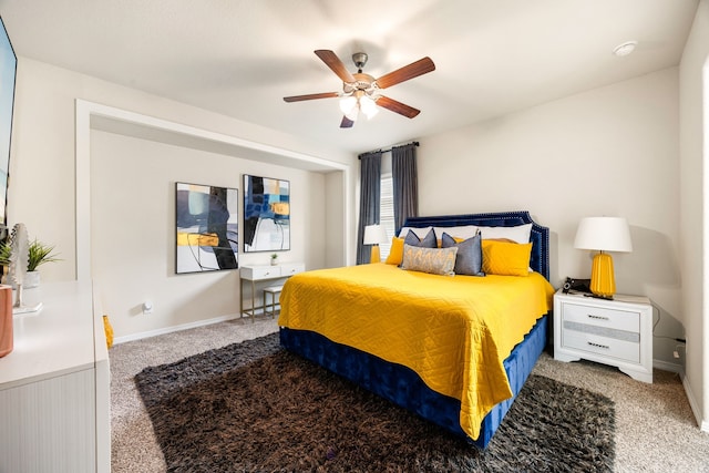 carpeted bedroom featuring ceiling fan and baseboards