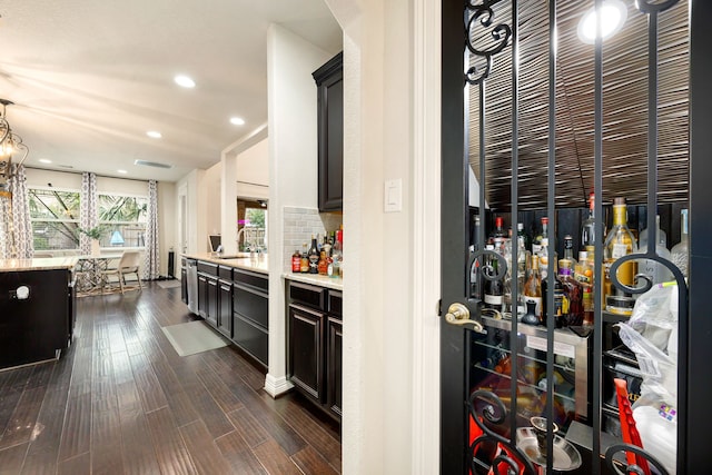 wine cellar featuring recessed lighting, dark wood-style flooring, a sink, visible vents, and a bar