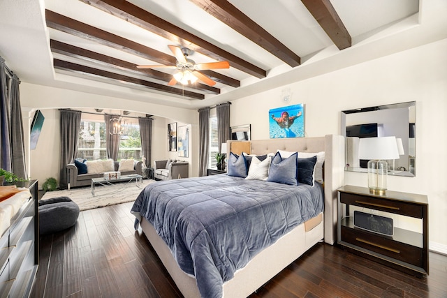 bedroom with dark wood-type flooring, a raised ceiling, beam ceiling, and a ceiling fan