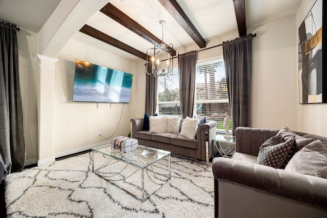 living area with arched walkways, baseboards, ornate columns, a chandelier, and beam ceiling