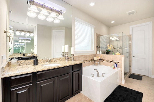 full bathroom with tile patterned flooring, visible vents, a garden tub, and a shower stall