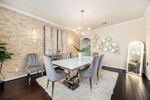 dining area featuring visible vents, arched walkways, ornamental molding, dark wood-style flooring, and a notable chandelier