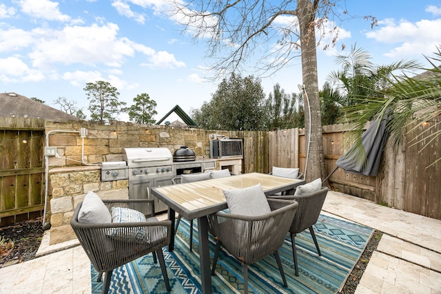 view of patio featuring outdoor dining space, area for grilling, and a fenced backyard