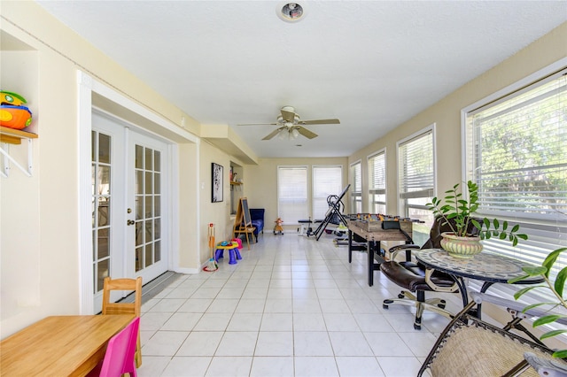 sunroom with french doors and a ceiling fan