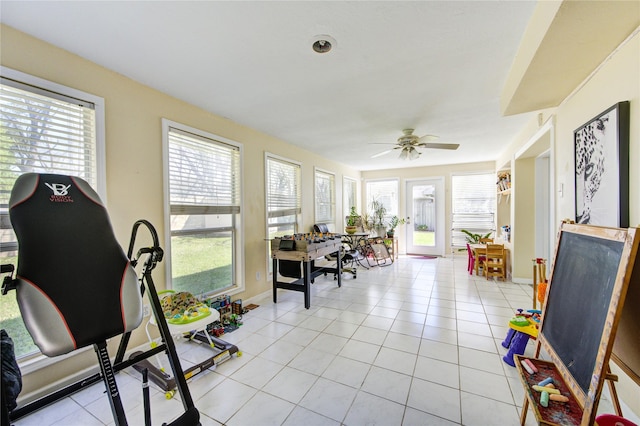 sunroom / solarium featuring ceiling fan