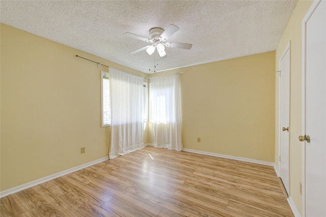 empty room with light wood-style floors, a textured ceiling, baseboards, and a ceiling fan