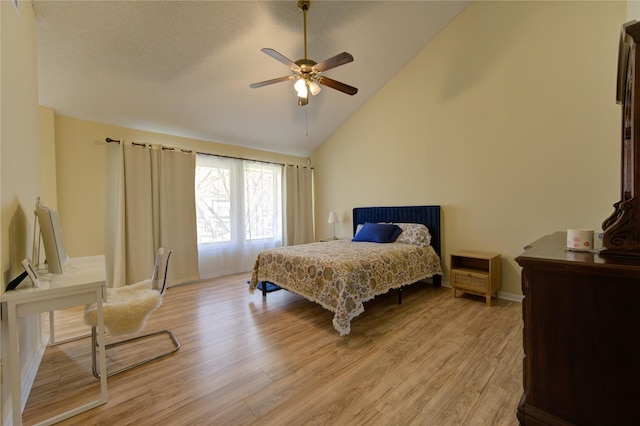 bedroom featuring light wood-style floors, a textured ceiling, baseboards, and a ceiling fan