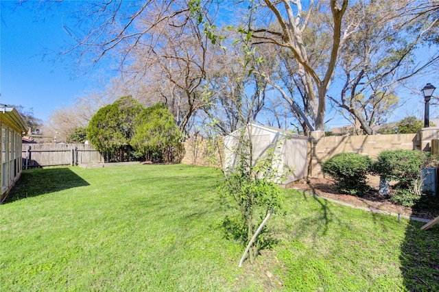 view of yard with a fenced backyard