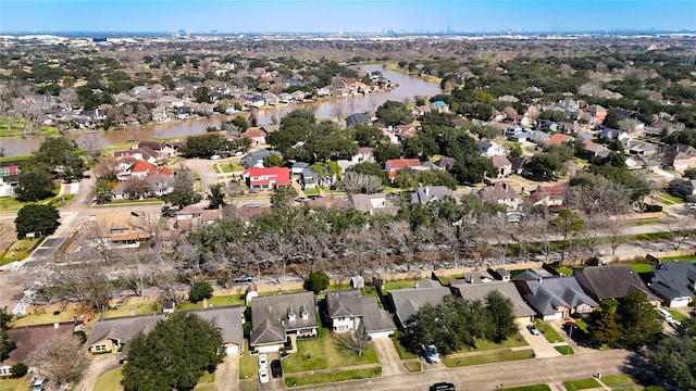 drone / aerial view with a water view and a residential view