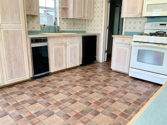 kitchen with a sink, white appliances, light countertops, and wallpapered walls