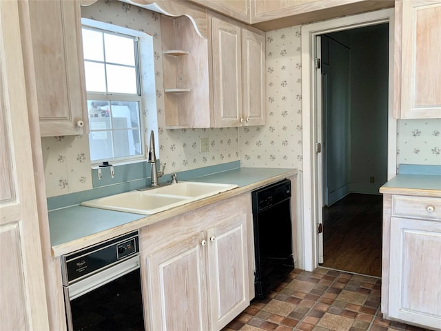 kitchen featuring a sink, wallpapered walls, light countertops, and dishwasher