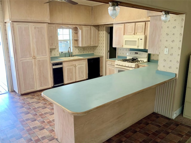 kitchen featuring light countertops, white appliances, and a peninsula