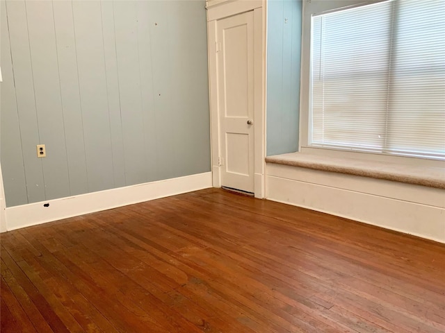 spare room with wood finished floors and baseboards