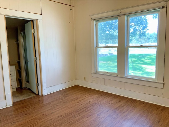 spare room featuring wood finished floors