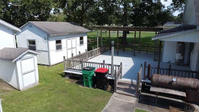 exterior space featuring gas water heater, a lawn, and a wooden deck