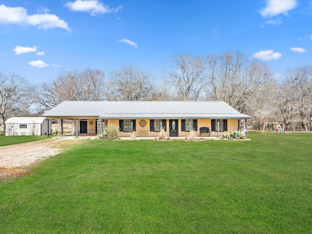 ranch-style house featuring driveway, metal roof, a porch, a carport, and a front yard