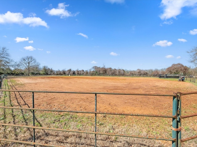 view of yard with an enclosed area and a rural view