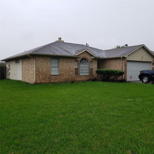 single story home featuring an attached garage, brick siding, and a front yard