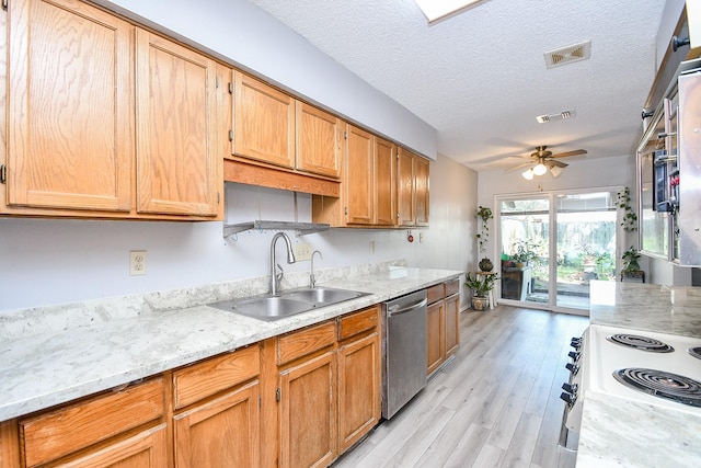 kitchen featuring stainless steel dishwasher, a sink, visible vents, and light stone countertops