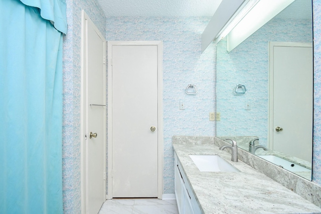 bathroom featuring marble finish floor and vanity