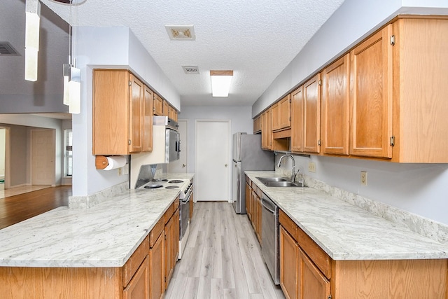 kitchen featuring a sink, visible vents, light wood-type flooring, brown cabinets, and white electric range oven