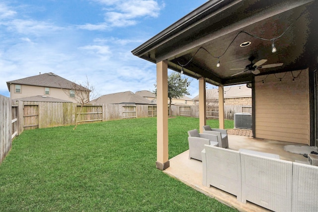 view of yard featuring a patio, ceiling fan, cooling unit, a fenced backyard, and an outdoor living space