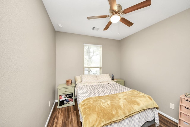 bedroom with baseboards, visible vents, and dark wood-type flooring