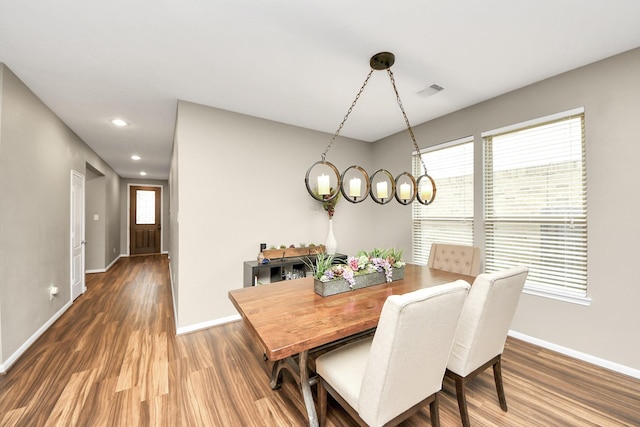 dining space with a healthy amount of sunlight, baseboards, and wood finished floors