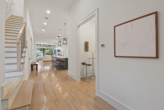 entrance foyer with recessed lighting, visible vents, light wood-style floors, baseboards, and stairs