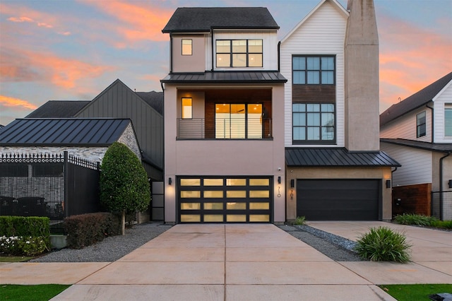 view of front facade featuring a garage, a standing seam roof, and metal roof