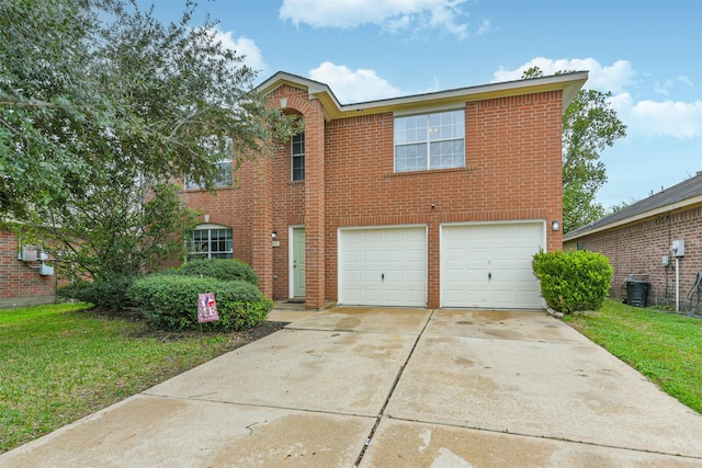 view of front of home featuring a front yard, brick siding, driveway, and an attached garage